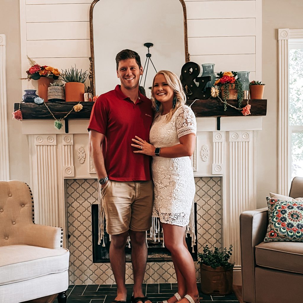 The cute couple in front of the vintage southwest mantle decor | The Yellow Rose Farmhouse | www.theyellowrosefarmhouse.com
