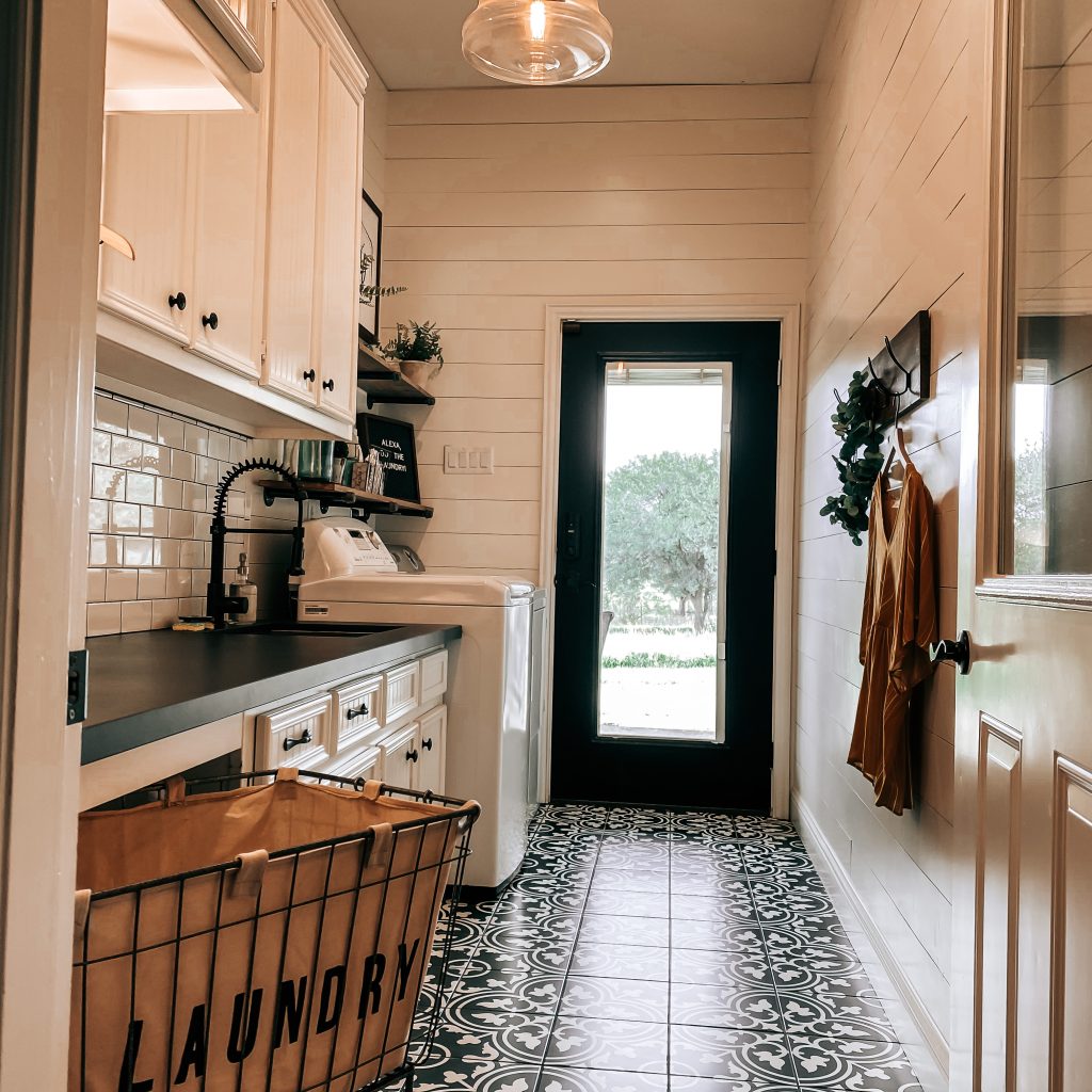 Farmhouse Laundry Room with vintage farmhouse decor, shiplap walls and hooks on wall before adding the DIY peg shelf | The Yellow Rose Farmhouse | www.theyellowrosefarmhouse.com