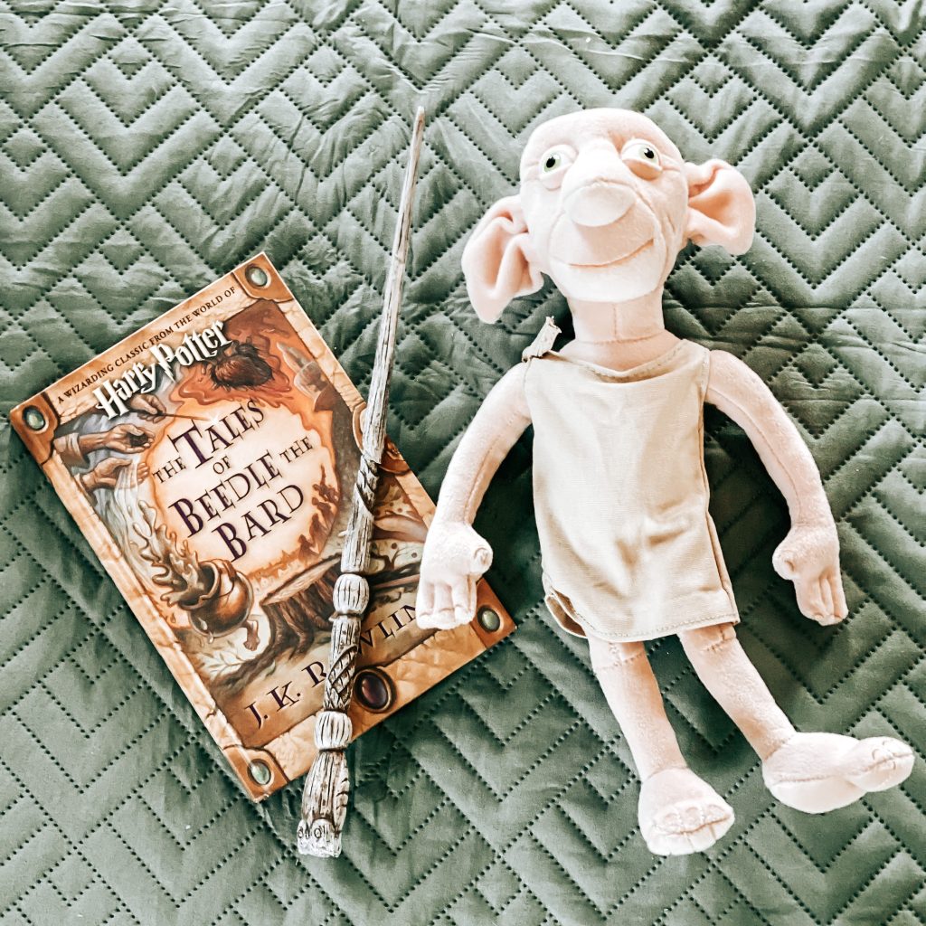 Close up of Dobby Plush toy, a magic wand and The Tales of Beedle the Bard from Harry Potter | The Yellow Rose Farmhouse | www.theyellowrosefarmhouse.com