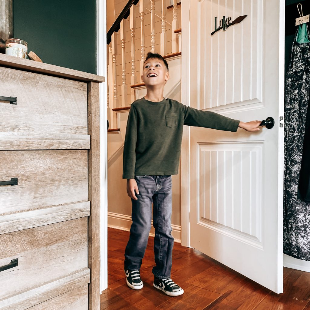 Boy seeing his Harry Potter Themed Bedroom for the first time and smiling from ear to ear | The Yellow Rose Farmhouse | www.theyellowrosefarmhouse.com 