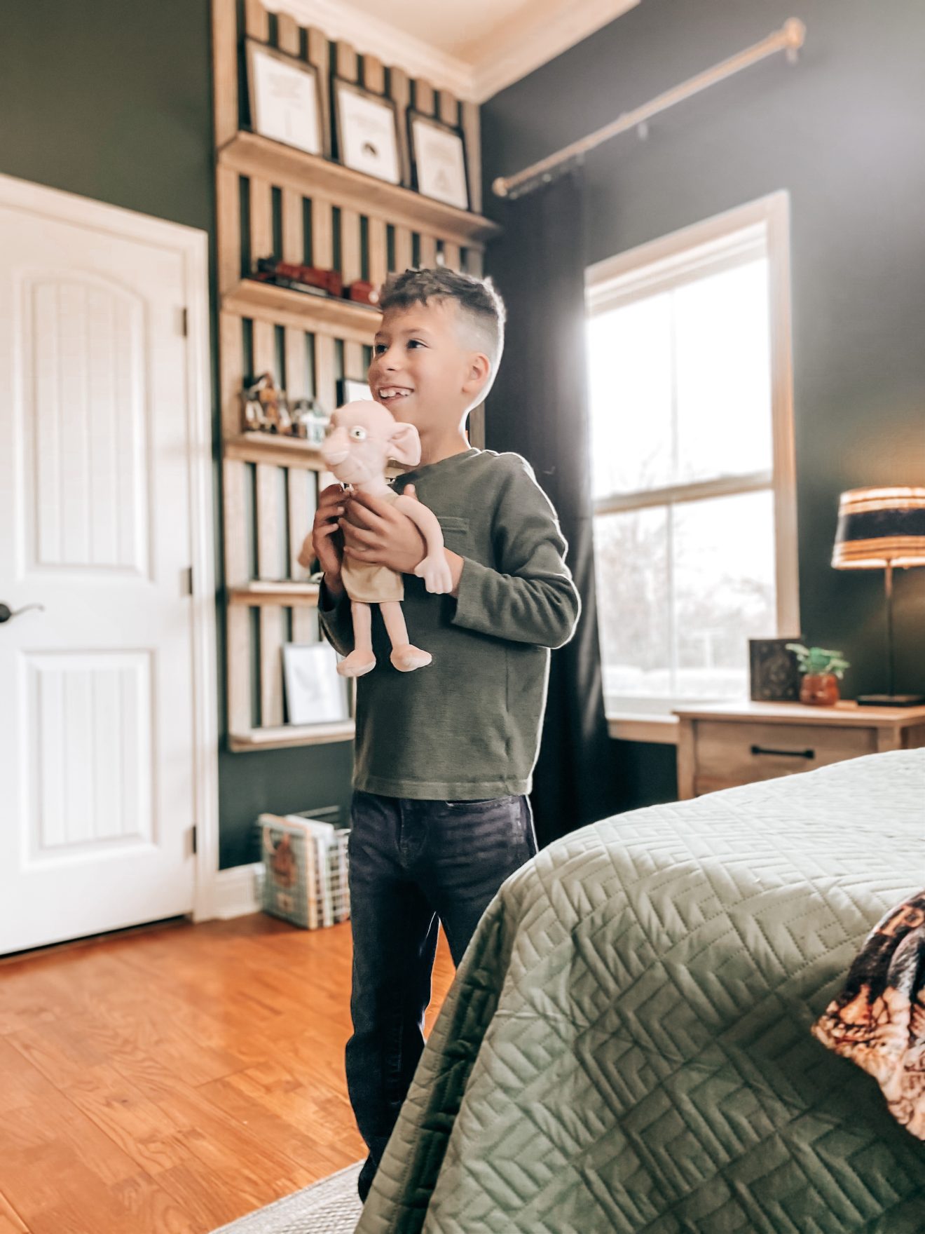 Boy seeing his Harry Potter Themed Bedroom for the first time, holding his Dobby plush toy and smiling from ear to ear | The Yellow Rose Farmhouse | www.theyellowrosefarmhouse.com 