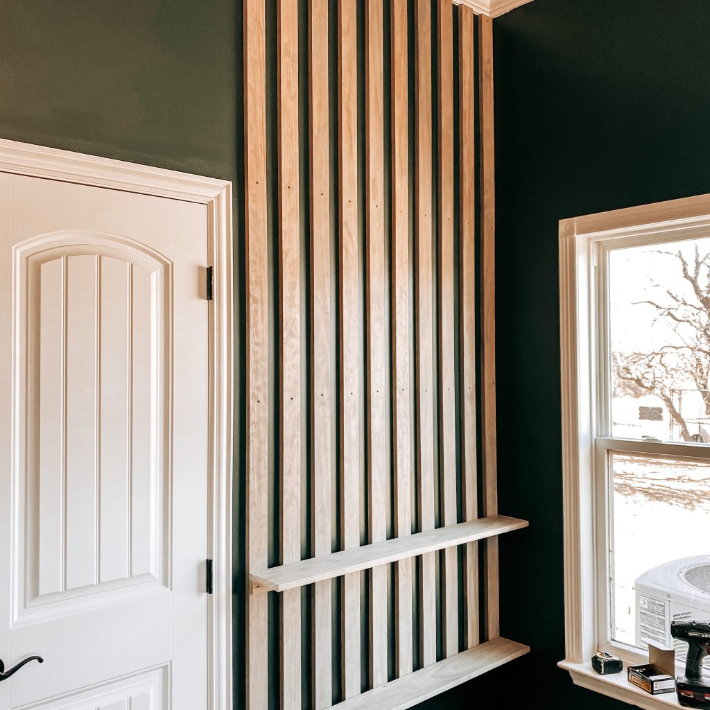 DIY Wood Slat Accent Wall with the bottom two shelves attached on a dark green wall in a Harry Potter Inspired boy's bedroom | The Yellow Rose Farmhouse | www.theyellowrosefarmhouse.com