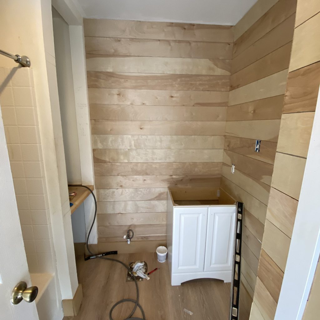 Modern Farmhouse Bathroom in the middle of renovations after installing the simple white vanity | The Yellow Rose Farmhouse | www.theyellowrosefarmhouse.com