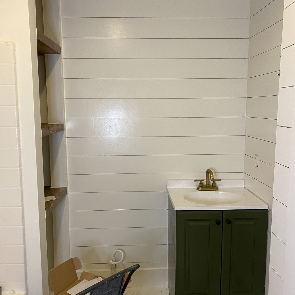 Modern Farmhouse Bathroom in the middle of renovations after installing the simple white vanity and painting it fresh basil green | The Yellow Rose Farmhouse | www.theyellowrosefarmhouse.com